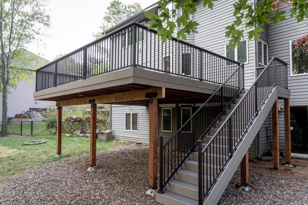 View of gray PVC deck with staircase and KDAT lumber frame. 