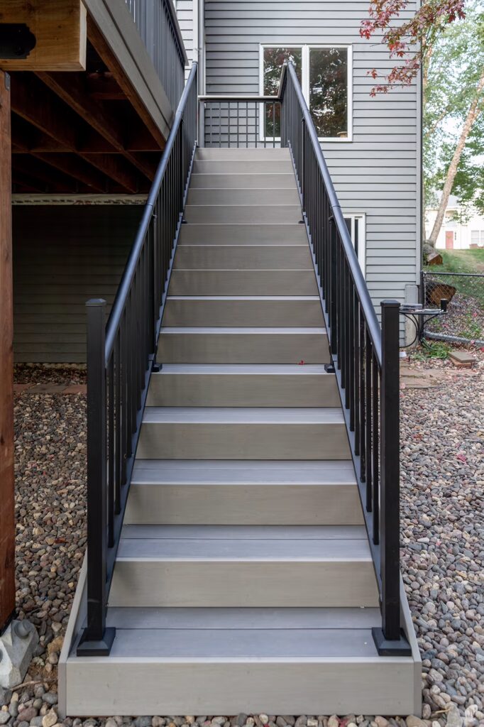 Front view of TimberTech Advanced PVC staircase with black aluminum railing. 