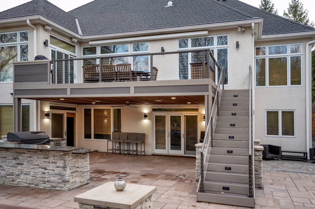 Custom feature-filled PVC deck on the back of a house.
