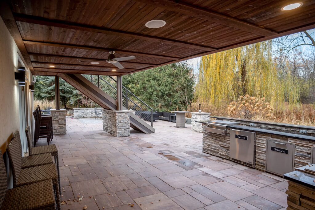 Lower portion of walk-out deck with cedar underdeck ceiling with integrated speakers, lights, and fan.