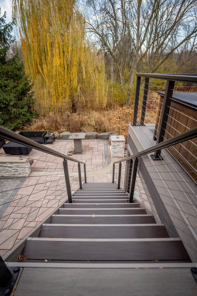 View from top of deck stairs looking down onto wetland with autumn colors.