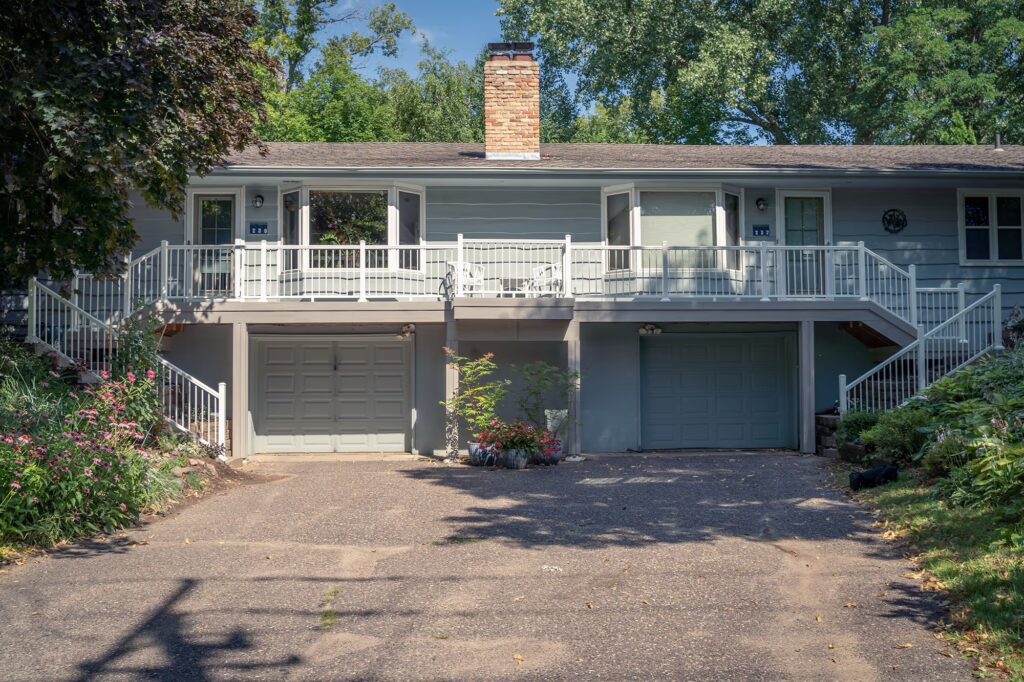 Front view of a duplex with composite deck above the garages.