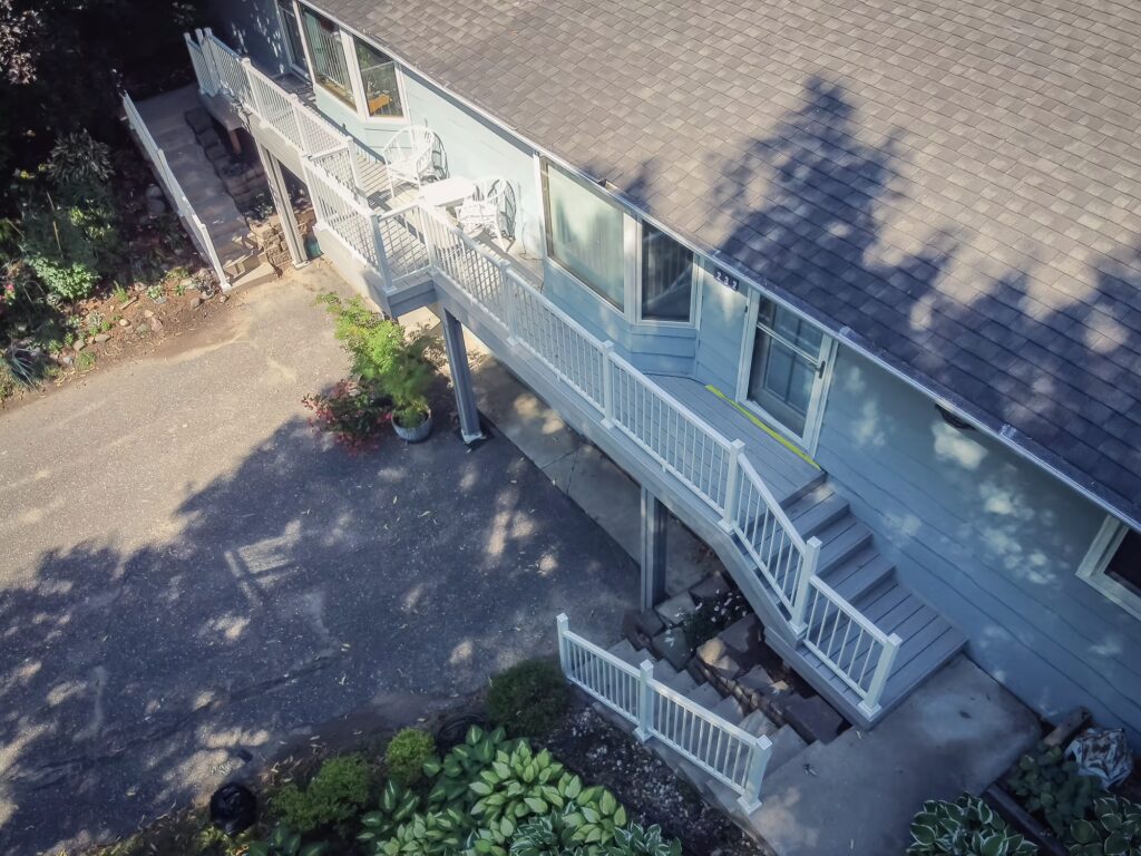 Aerial view of a long deck spanning the length of two duplexes using TimberTech Advanced PVC.