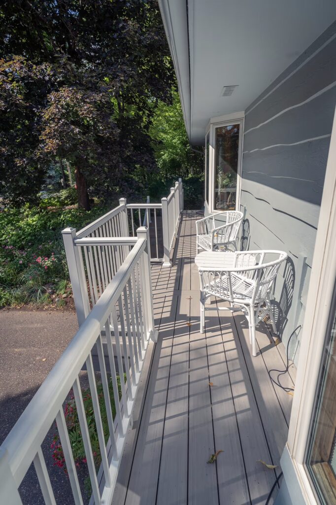 Long composite deck with small bump-out in the center for white seating set.