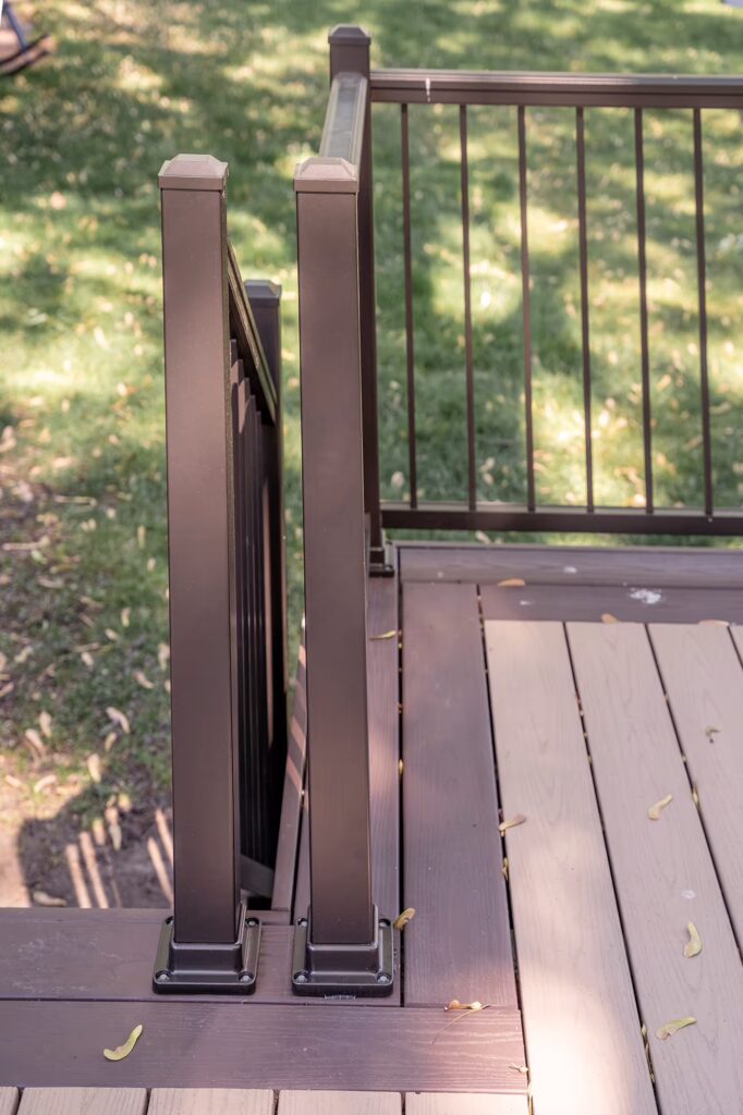 PVC deck with custom bump-out for grill, surrounded by bronze aluminum railing from TimberTech.