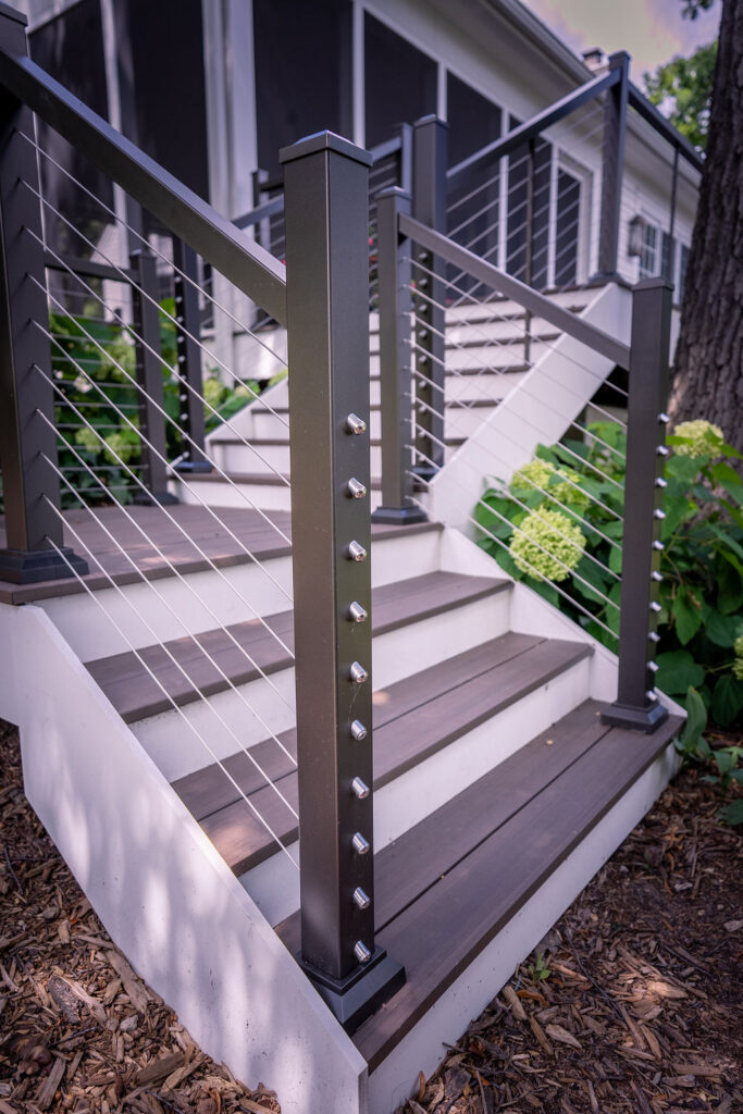 Details of cable railing on end post of aluminum deck railing.