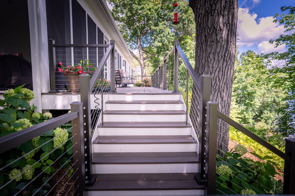 Upper portion of L-shaped deck stairs with contrasting risers.