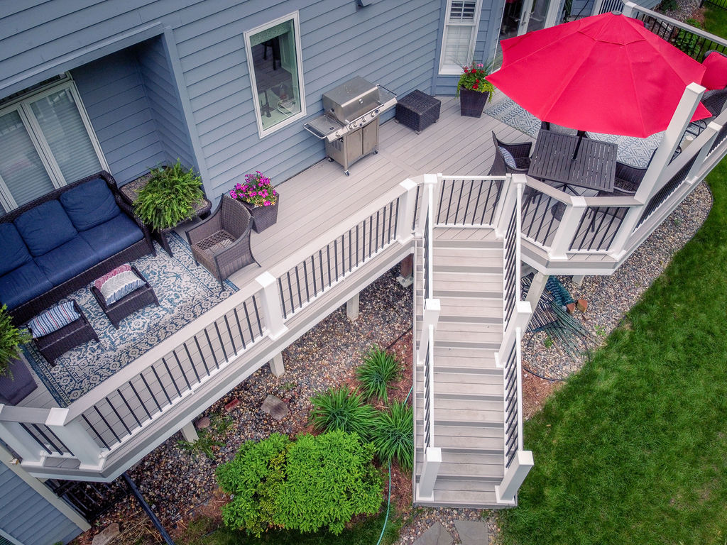 Aerial view of low-maintenance tan deck with angled stairs leading to ground level.