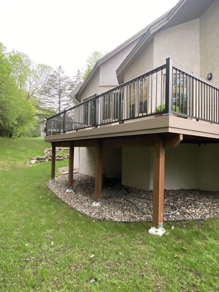 Side deck with black railing and TimberTech Advanced PVC Brownstone fascia.