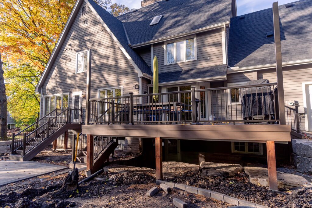 Front view of backyard deck with wood framing and TimberTech Advanced PVC decking. 