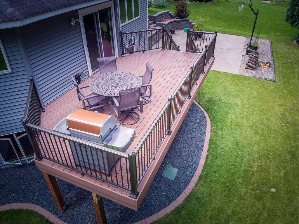 Aerial side view of a PVC deck cantilevered over a wood frame. 