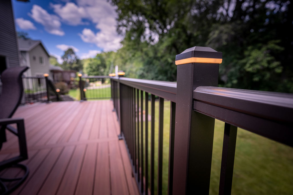 Detail view of TimberTech Impressions aluminum railing with integrated post cap lights. 