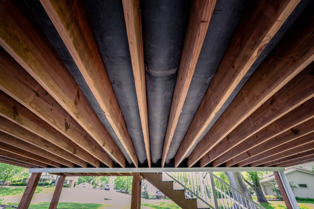 Underneath a composite deck with a KDAT lumber frame and EPDM drainage system. 