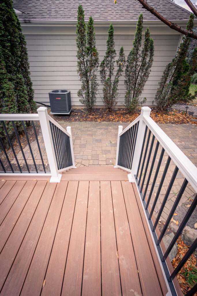 Top view of PVC stairs with aluminum railing with black-and-white tuxedo coloring.