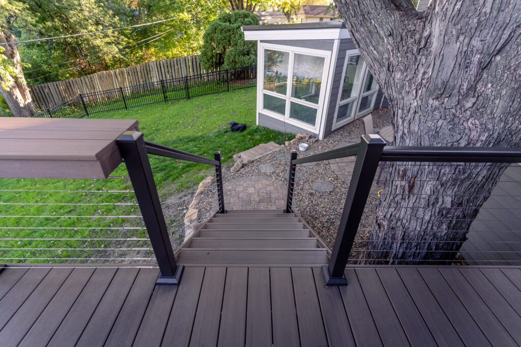 Top view of low-maintenance deck staircase with aluminum cable railing.