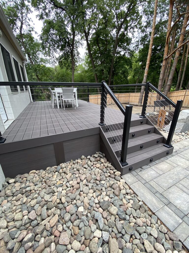 Deck on the back of a house using TimberTech Advanced PVC in Dark Hickory. 