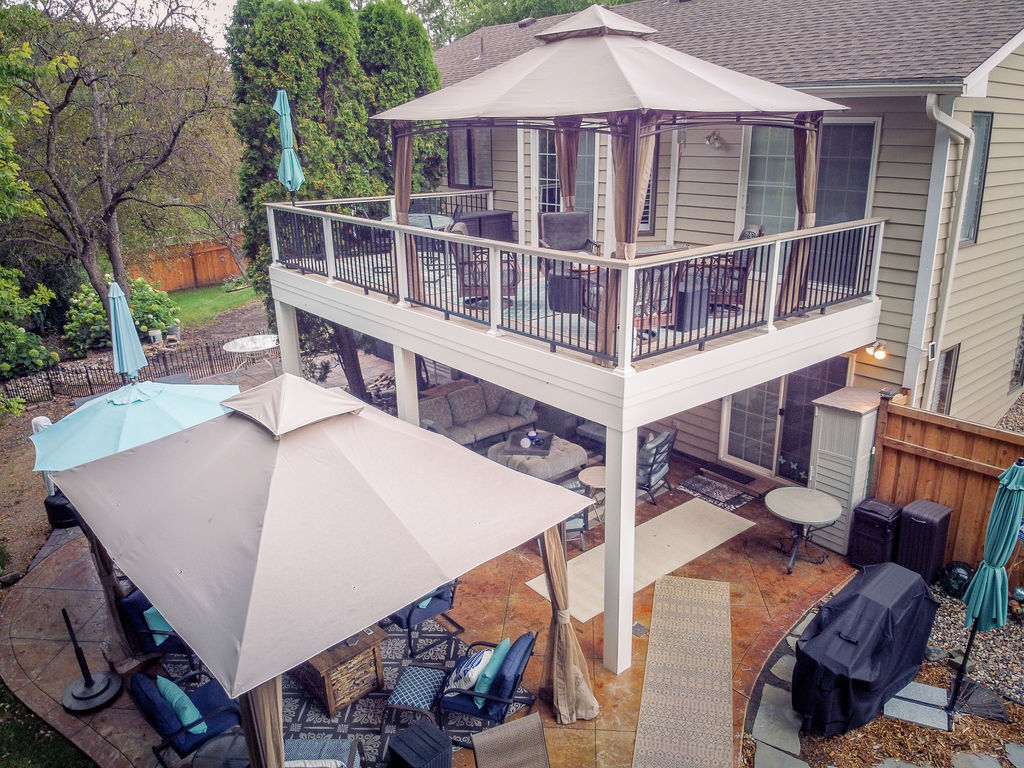 Aerial view of low-maintenance deck with an abundance of furnishings on top, below, and to the side.