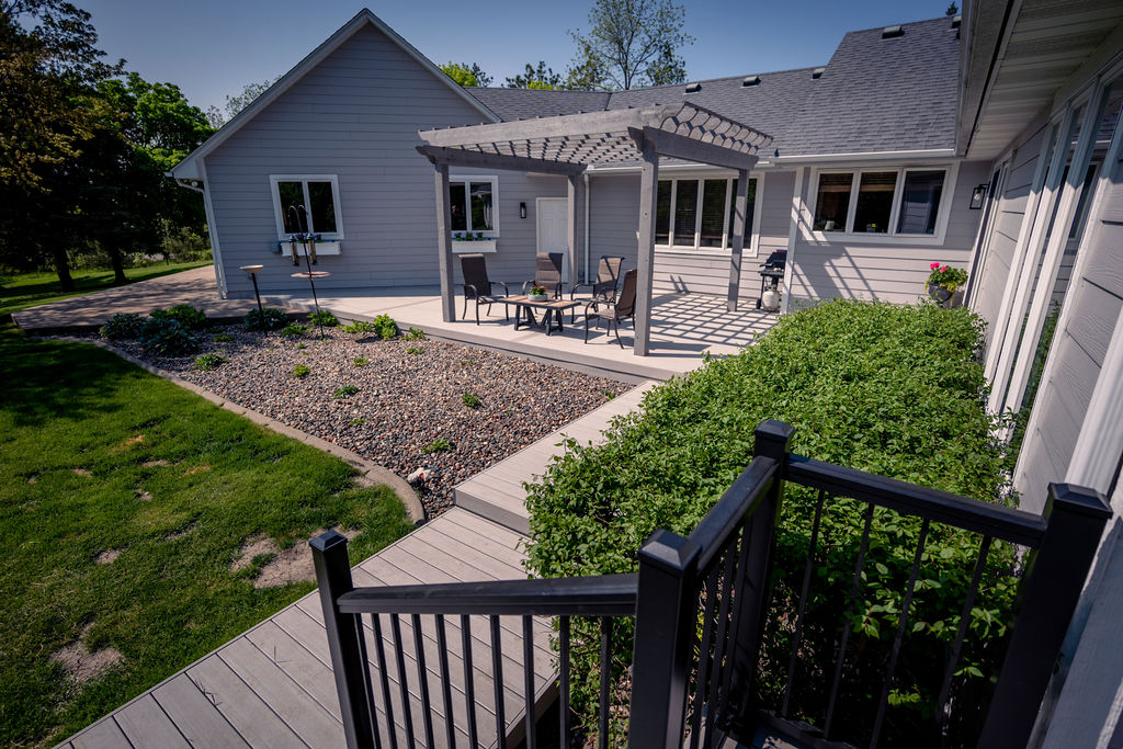 View from top of deck stairs towards PVC deck and cedar pergola.