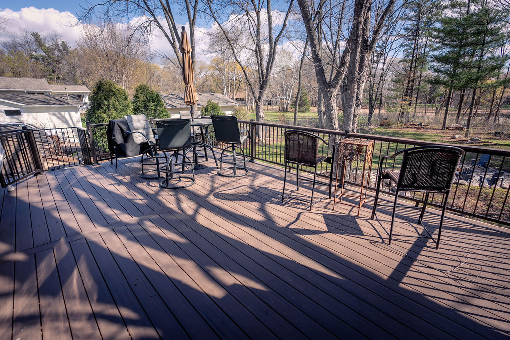 Upper level of low-maintenance deck looking towards the spiral staircase leading down to the lower level.