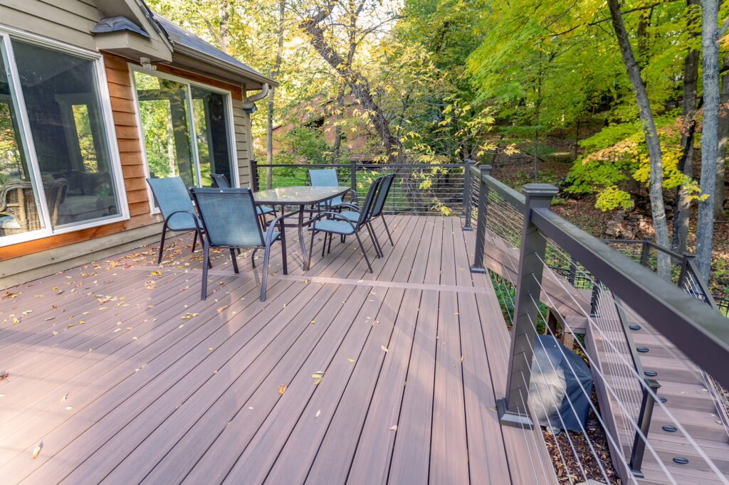 Alternate view of PVC deck with dining furniture on a fall day. 