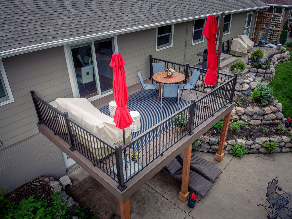 Aerial view of a small composite deck on the back of a house without any stairs.