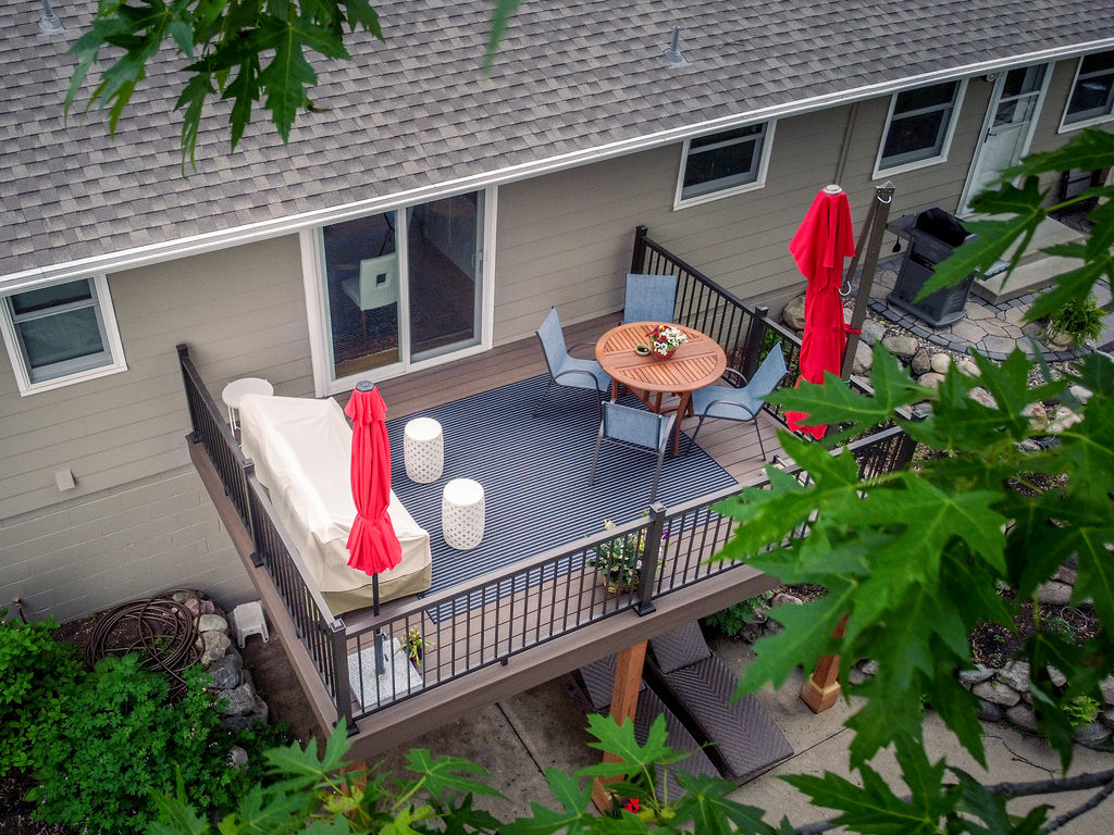Aerial view of a 200 square foot composite deck with cozy furnishings.
