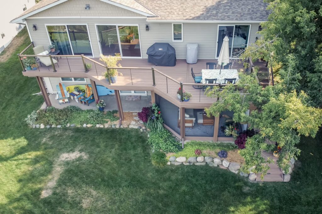Aerial view of a low-maintenance deck with a screened-in porch underneath. 