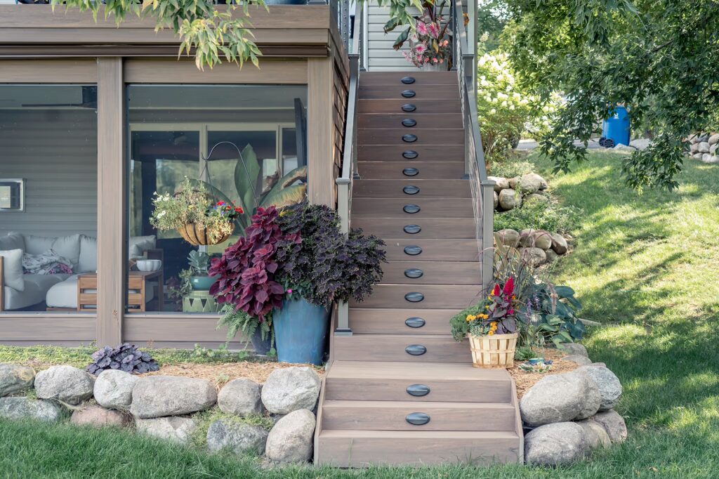 Screened-in porch with exterior stairs on the right side, all using TimberTech Advanced PVC.