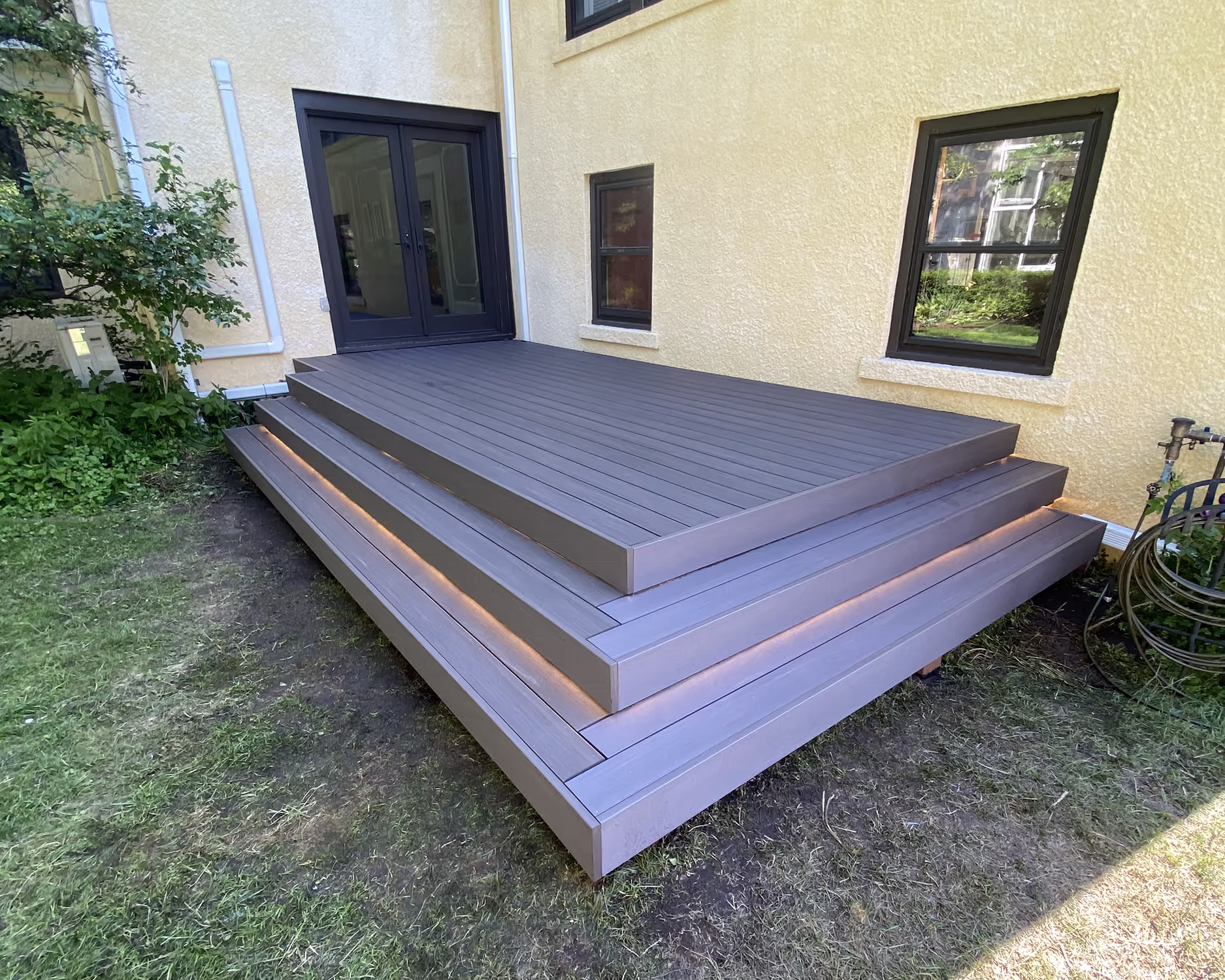 A platform deck with wraparound steps and integrated stair lights.