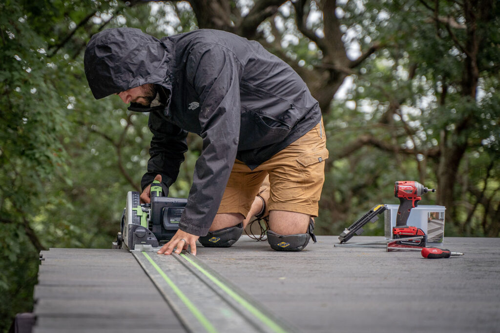 Josh Ferri reviewing job site conditions while overseeing a premium deck project in the Lake Minnetonka area.