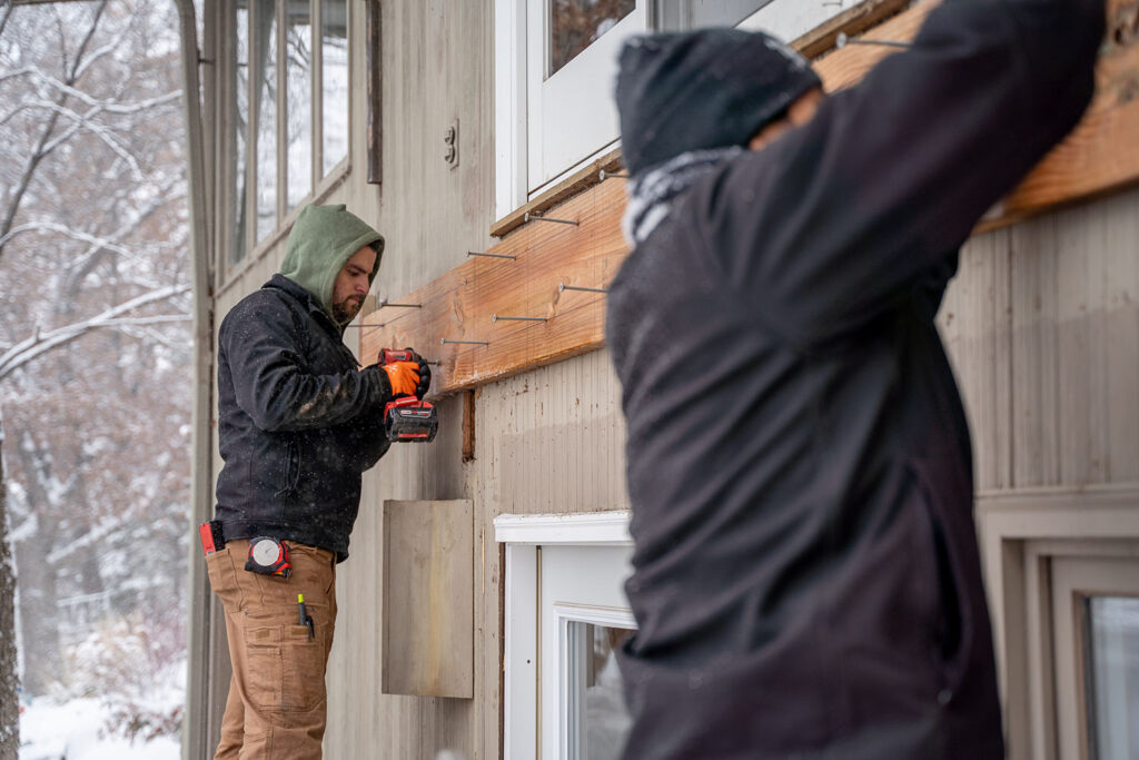 Lakeside Decking CEO Josh Ferri inspecting framing and construction progress on a deck build.