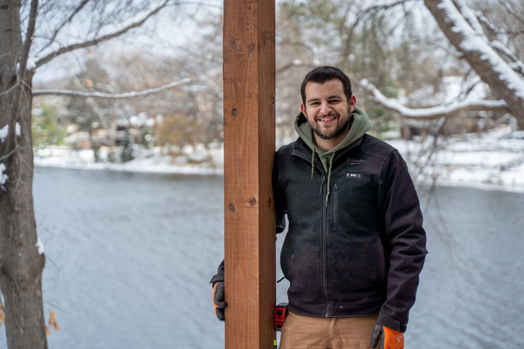 CEO Josh Ferri standing on a winter build deck frame built by Lakeside Decking in the West Metro area.